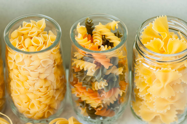 Assortment of different shapes whole grain raw Italian pasta in  - Valokuva, kuva