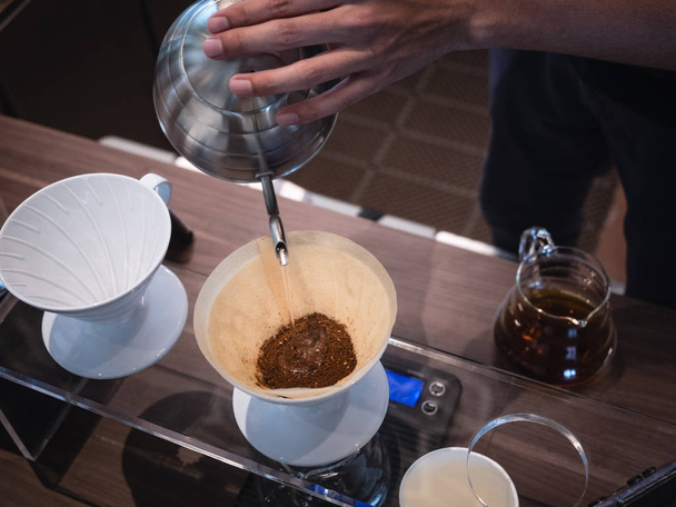 Hand drip coffee Barista pouring water on coffee ground - Foto, afbeelding