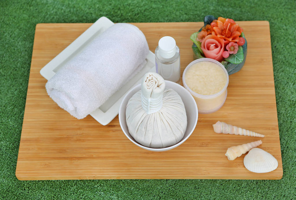 Spa herbal compressing ball with towels and Salt Scrub, Spa concept on bamboo board against white background - Foto, afbeelding