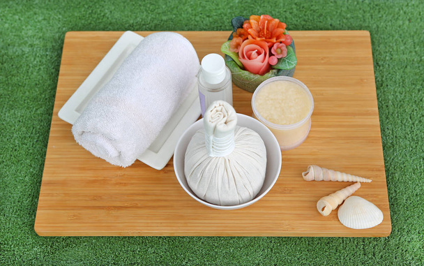 Spa herbal compressing ball with towels and Salt Scrub, Spa concept on bamboo board against white background - Φωτογραφία, εικόνα