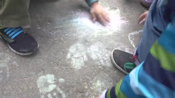baby hand drawing with colored chalks on the pavement - Footage, Video