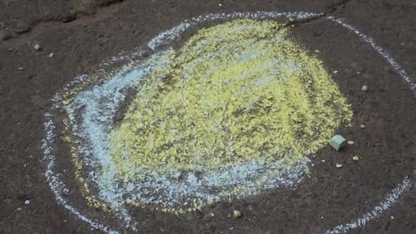 baby hand drawing with colored chalks on the pavement - Footage, Video