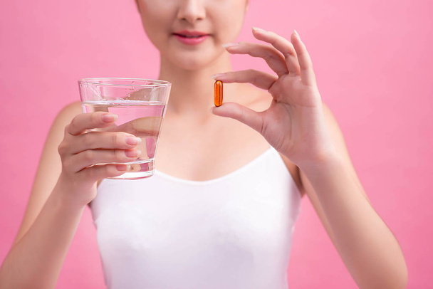 young woman holding pill - Foto, Imagem