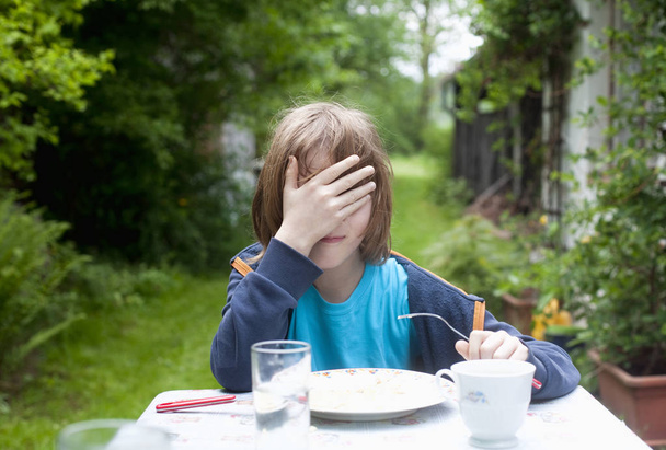 Boy with Blond Hair Eating Outdoors - Fotoğraf, Görsel