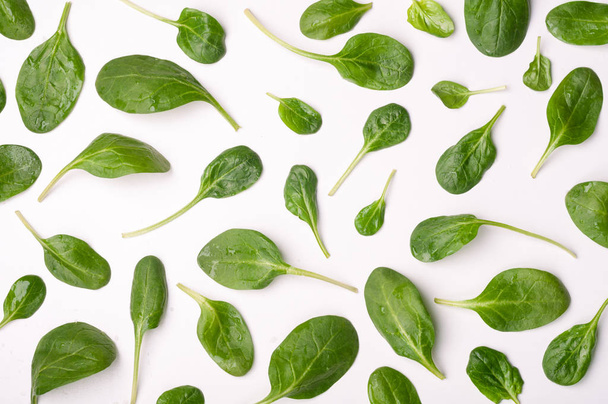 Spinach leaves on white background. Pattern of spinach leaf isolated background. Creative food concept. Ingredient for salad. Flat lay - Fotografie, Obrázek