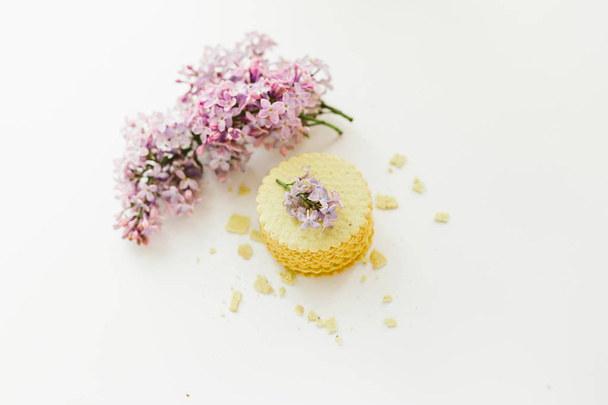 stack of cookies accompanied with lilac flowers - Fotografie, Obrázek