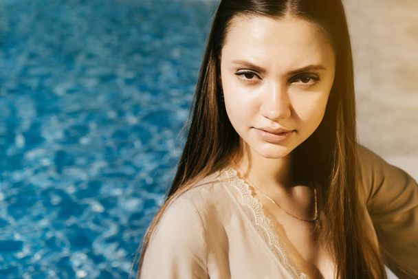 Young fashion woman near swimming pool,copyspace,hot summer - Foto, immagini