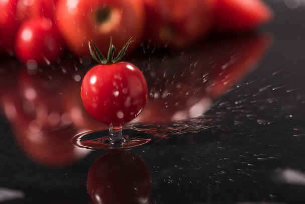  Tomatoes on black background ,water drops , mirror - Foto, Imagem