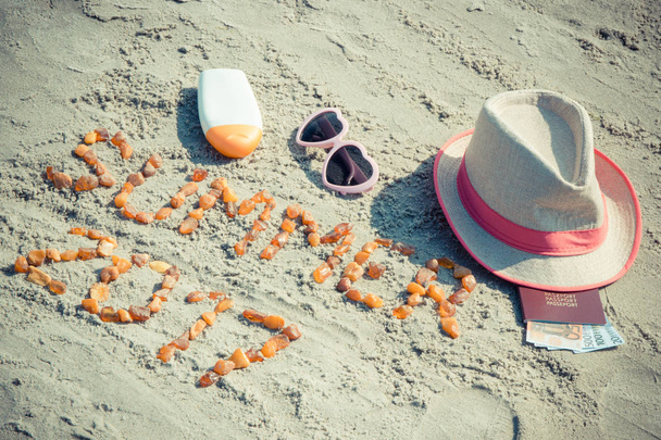 Inscription summer 2017, accessories for sunbathing and passport with currencies euro on sand, summer time concept - 写真・画像