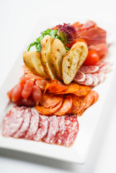 meat appetizer on white plate - Foto, immagini
