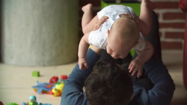 Father plays with little boy on the floor - Felvétel, videó