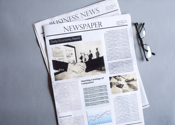 Reading newspaper on desk - Foto, afbeelding