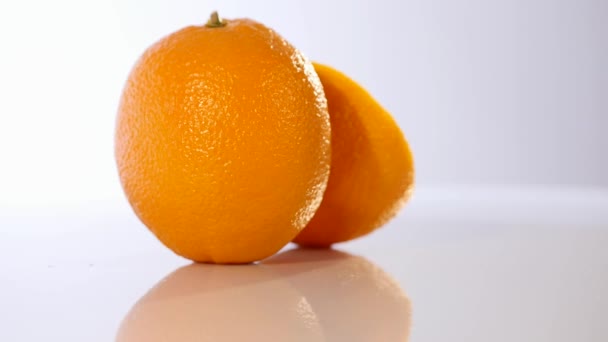 orange with half of orange isolated on the white background - Кадри, відео