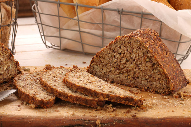 Whole grain bread on a wooden board - Foto, afbeelding