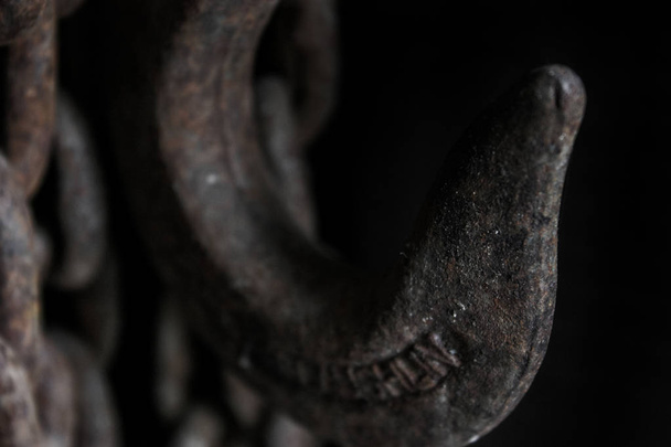old chain hook on black background - Photo, Image