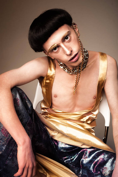 Guy in the golden clothes. Fashion abundance concept - Foto, afbeelding