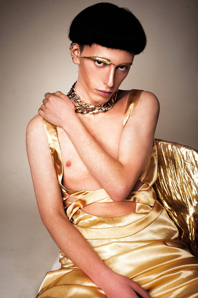 Guy in the golden clothes. Fashion abundance concept - Fotó, kép