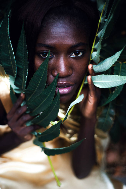 Dark skin model from Nigeria in the golden satin dress. - Photo, image