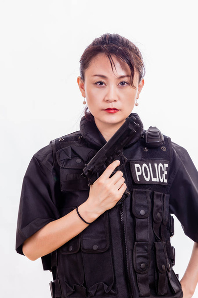 Chinese woman police officer with pistol - Фото, изображение