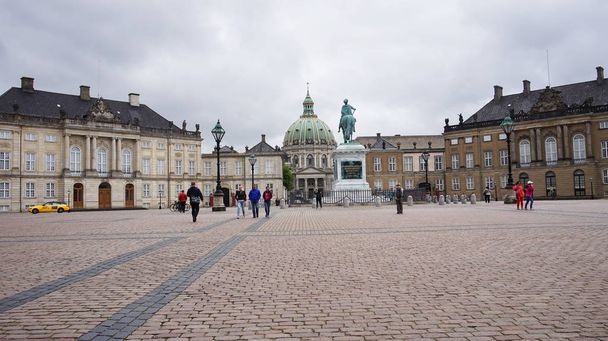 COPENHAGEN, DENMARK - MAY 31, 2017: Amalienborg Slotsplads square with a monumental equestrian statue of Amalienborg's founder, King Frederick V and Frederik's Church on the background, Copenhagen  - Photo, image