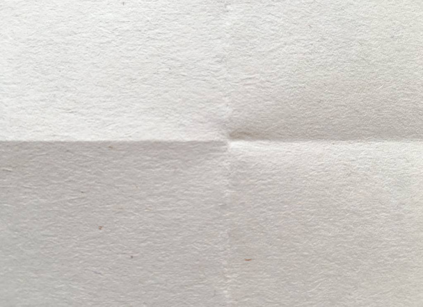 White sheet of paper folded. Crushed and folded white sheet of paper. Note paper. Wrinkled paper - Photo, Image