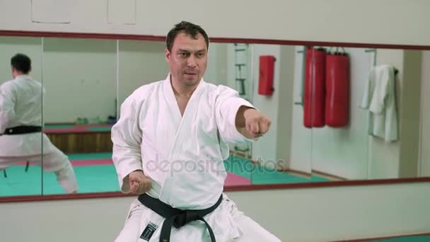 A sportoló a fehér ruhákat teljesítő egy karate 4k - Felvétel, videó