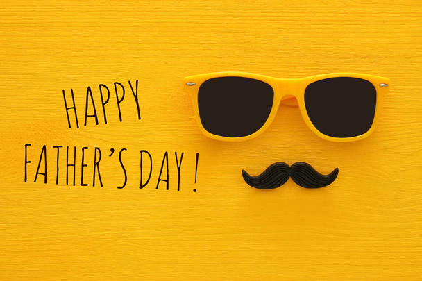 Father's day concept. Hipster yellow sunglasses and funny moustache - Valokuva, kuva