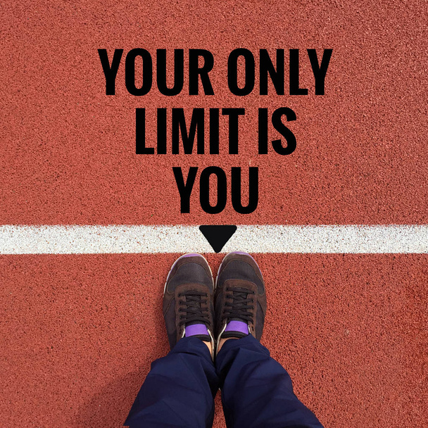 Inspirational quote "your only limit is you" on running track - Foto, afbeelding