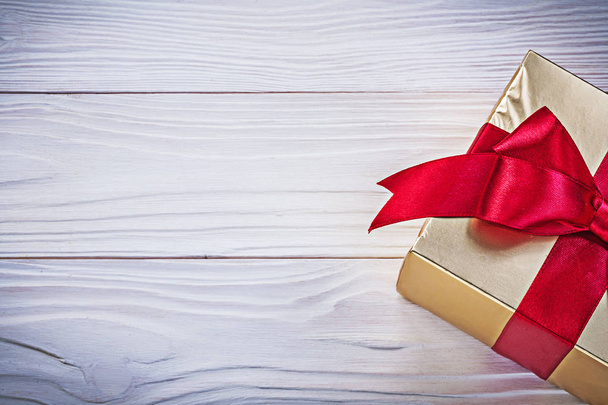 Birthday gift box with red satin tape on wooden board holidays c - Φωτογραφία, εικόνα