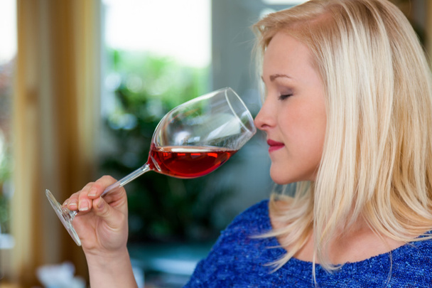 Woman with red wine in a wine glass - Photo, Image