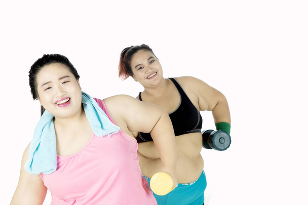 Obese women doing workout with dumbbell - Foto, afbeelding