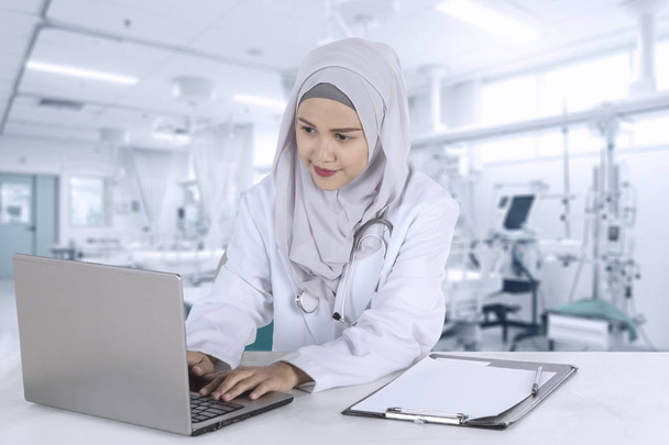 Pretty muslim doctor works with laptop - Valokuva, kuva