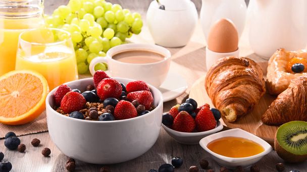 Breakfast served with coffee, juice, croissants and fruits - Fotoğraf, Görsel