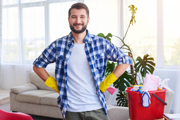 Happy man being pride of finishing cleaning works - 写真・画像