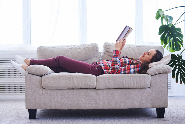 Graceful girl having rest while reading book - Photo, Image