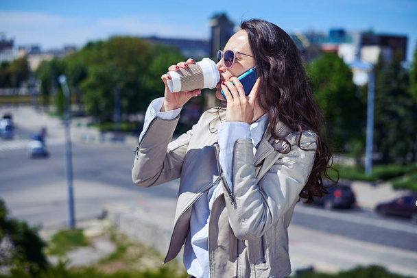 Gorgeous lady talking on phone while drinking coffee - Photo, Image