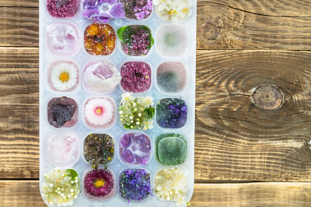 Tray with Frozen Flowers in Ice Cubes - Photo, Image