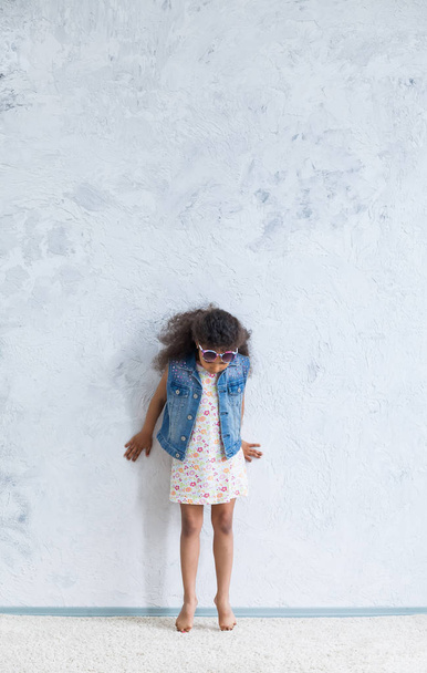 Cute afro girl against the gray wall - Photo, image