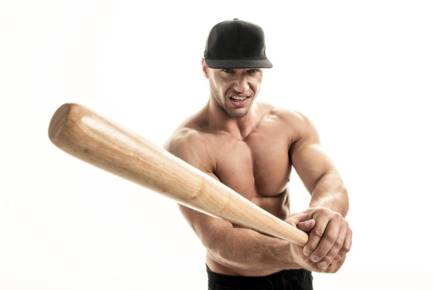 Close-up portrait of muscular man posing with a bat - Foto, afbeelding