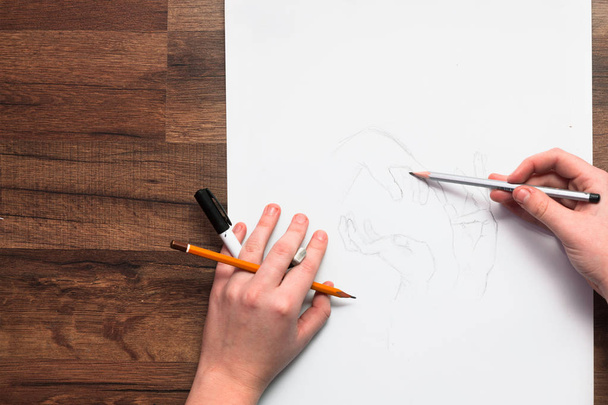 Painters hands drawing sketch with pencil - Fotó, kép