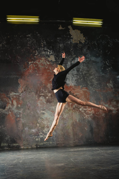 Dance. The girl dances in a black jacket - Photo, Image