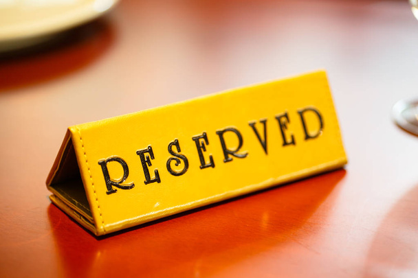 A sign on the reserved table in the restaurant. - Photo, Image