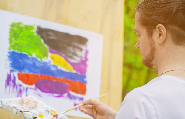 Artist painting a colorful landscape  - Photo, image