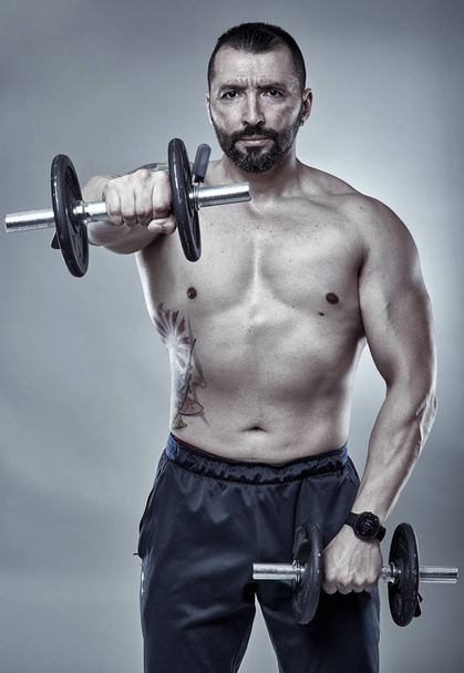 Fitness trainer doing shoulder workout - Fotó, kép