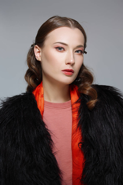 Beautiful fashion model in fur coat. Clean fresh face of pretty  - Фото, зображення