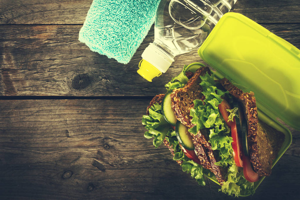 Healthy Life Sport Concept. Sport Towel, Water, Healthy Sandwich - 写真・画像