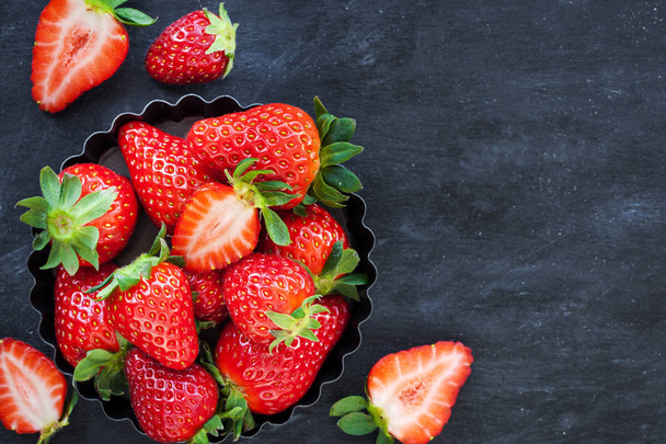 Fresh ripe strawberry on dark background - Foto, afbeelding