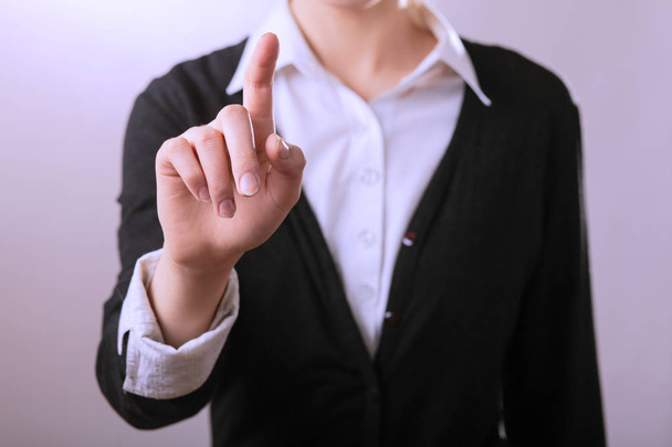 Business woman pointing finger. Isolated on gay background - Photo, Image