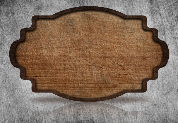 Brown wooden ornate, scratched signboard with dark frame and reflection on grunge metal background. - Foto, imagen