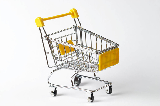 Metallic shopping trolley over white background - Фото, изображение
